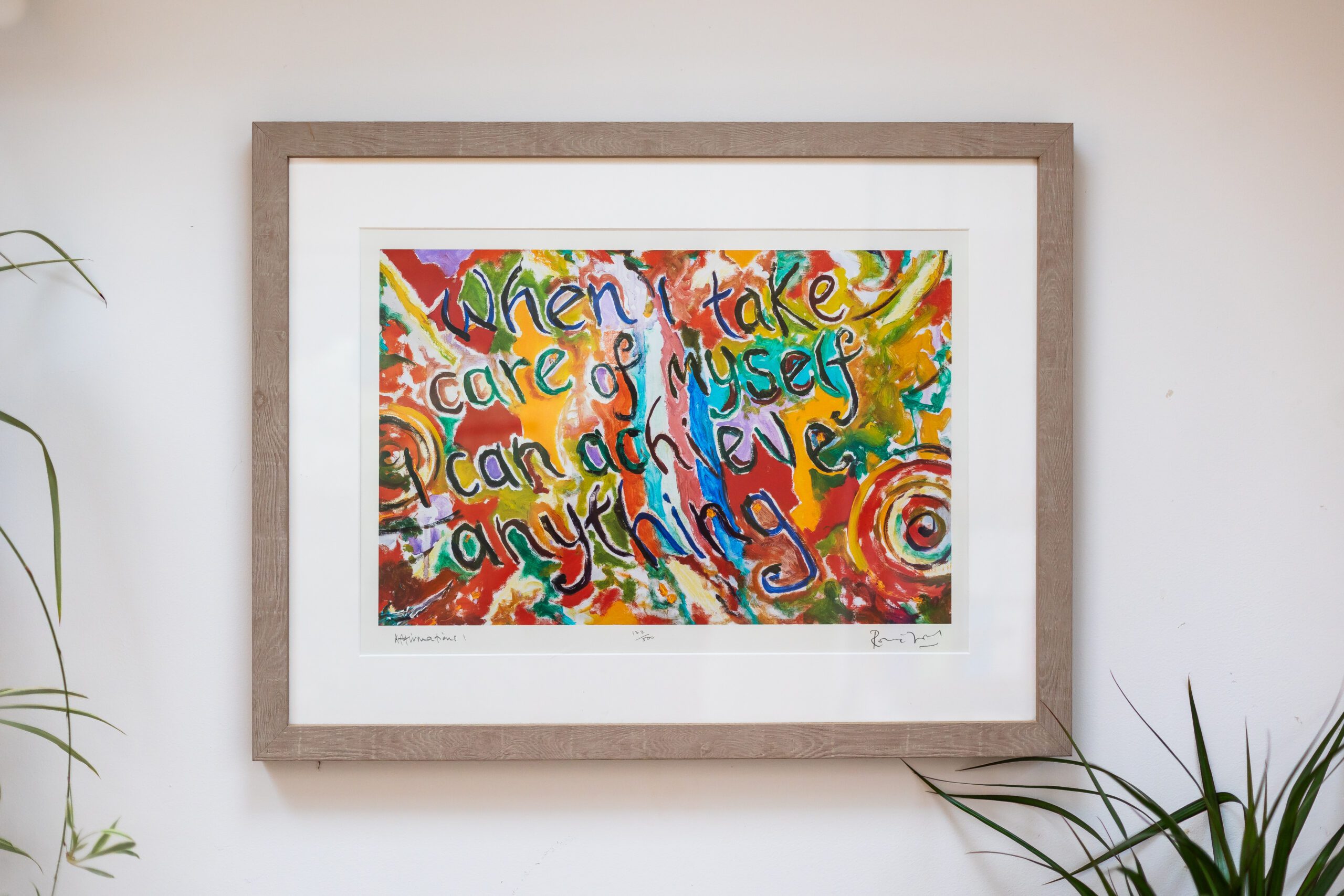 A painting on Beverley Harper's therapy room wall with swirls of bright colour and text that reads: When I take care of myself, I can achieve anything.