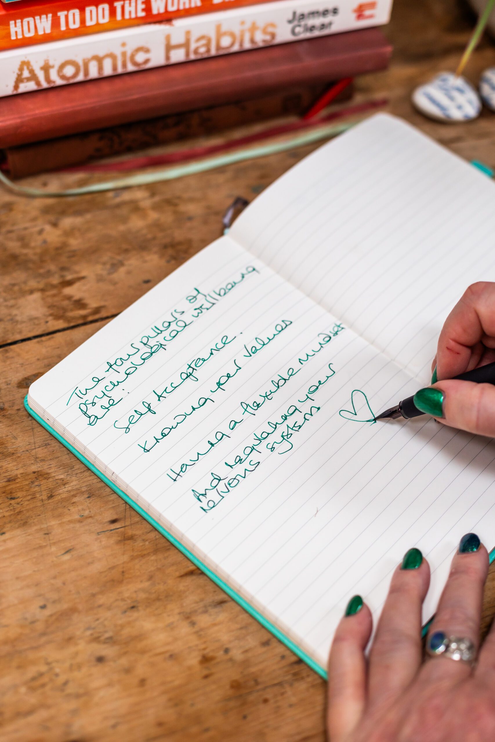 Beverley Harper Psychological Wellbeing coach writes in a journal.