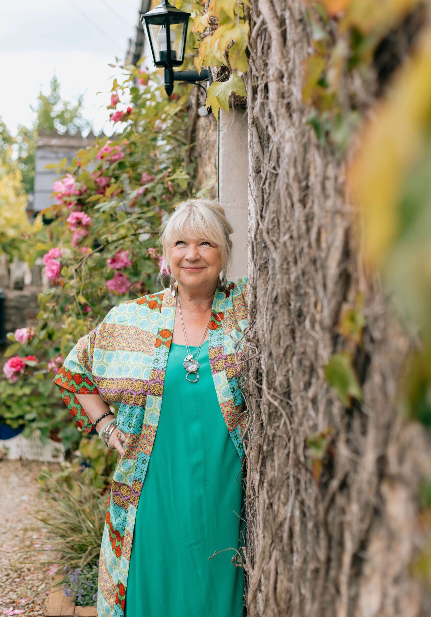 Therapist, Beverley Harper stands outside an English cottage.