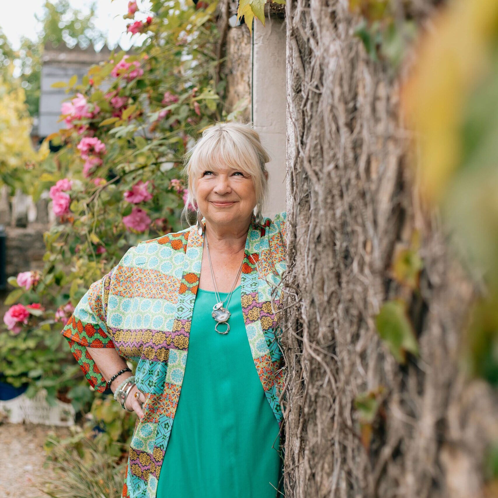 Therapist, Beverley Harper stands outside an English cottage.