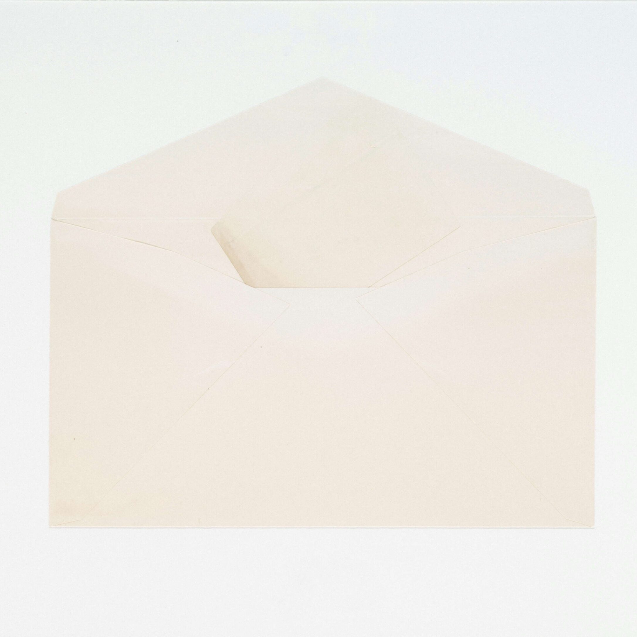 A vintage cream coloured envelope, open.